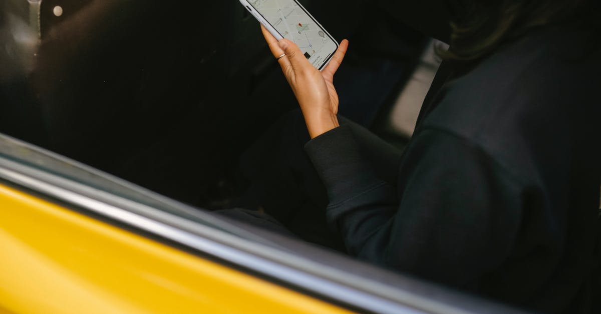 What are the yellow bars on map locations in The Division? - Crop passenger with navigator app on smartphone in taxi vehicle