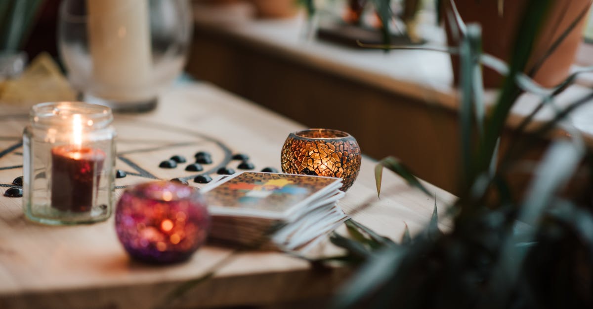 What can I do if I set myself on fire to stop being fire? - Luminous candles in holders near tarot cards on table with oracle symbol at home What can I do if I set myself on fire to stop being fire? - Luminous candles in holders near tarot cards on table with oracle symbol at home