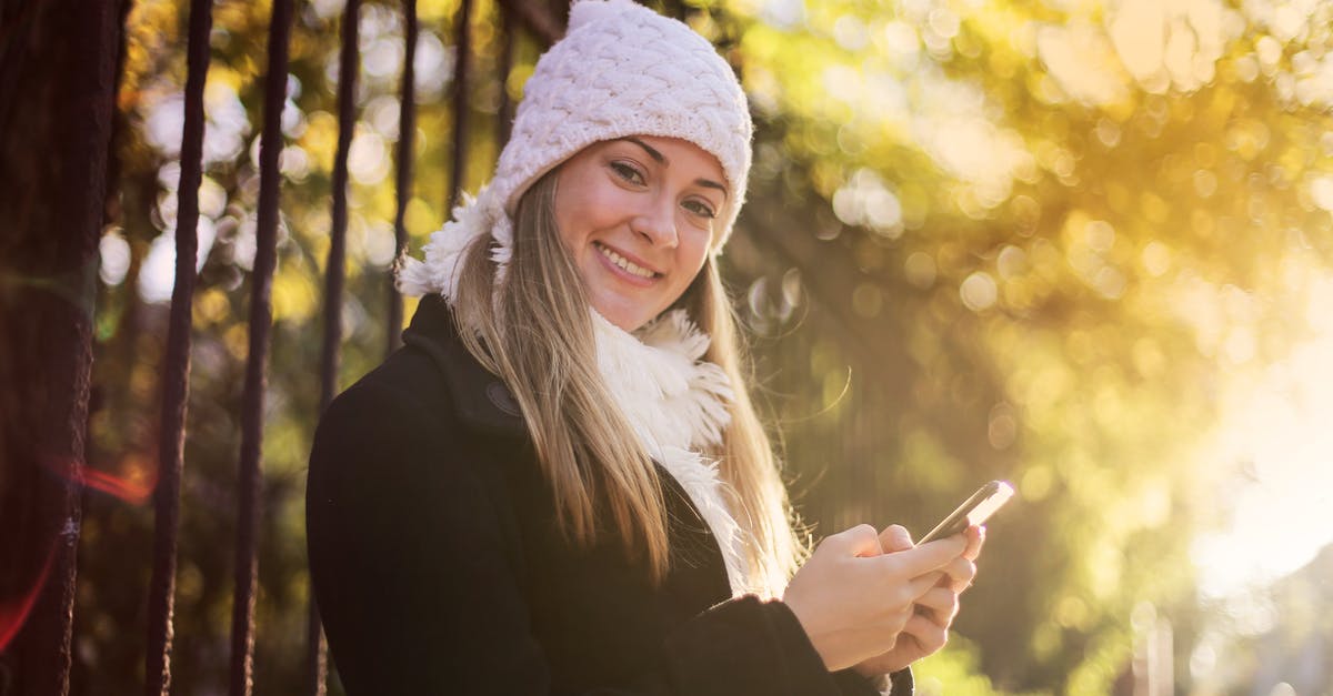 What can I make using the atronach forge - Smiling woman chatting on smartphone in park