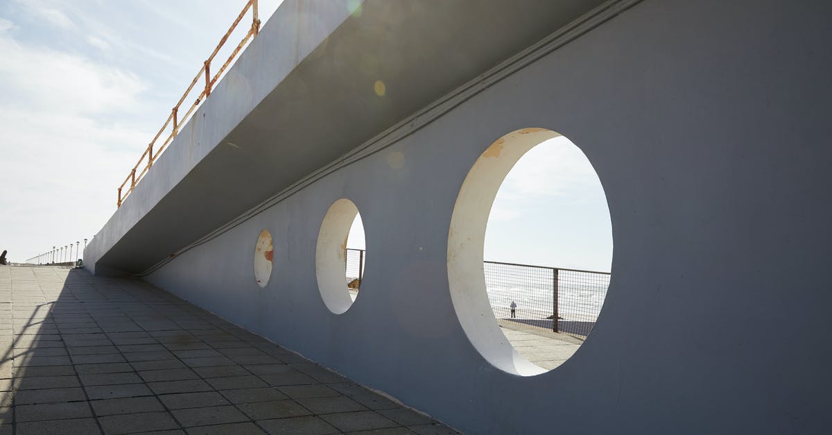 What do the circle of stones represent? - Holes in wall of bridge in daytime