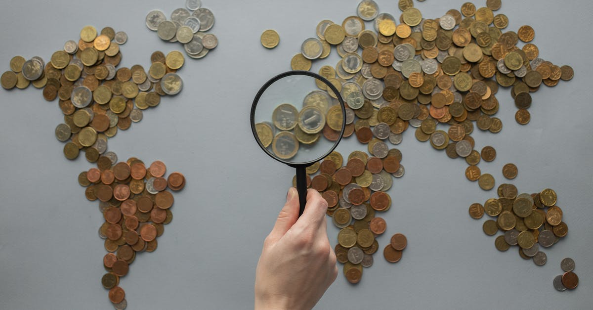 What do the gray exclamation points on the map mean? - Anonymous person with magnifying glass over world map of coins