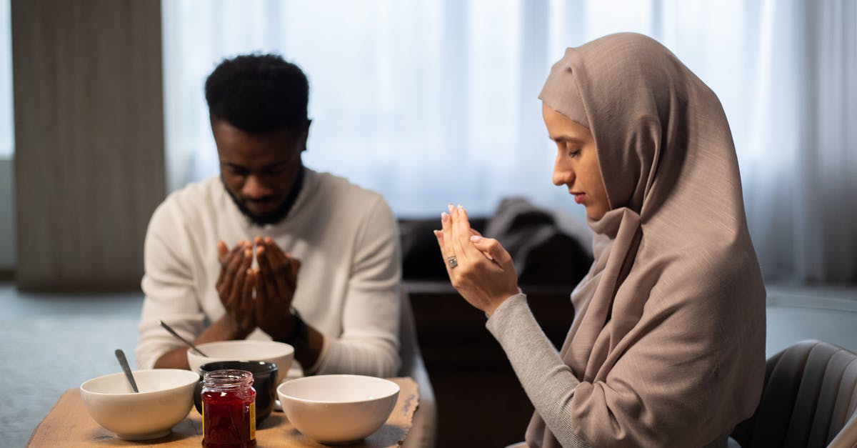 What does buying a wish in Sega's Aladdin do? - Multiethnic couple praying at table before eating