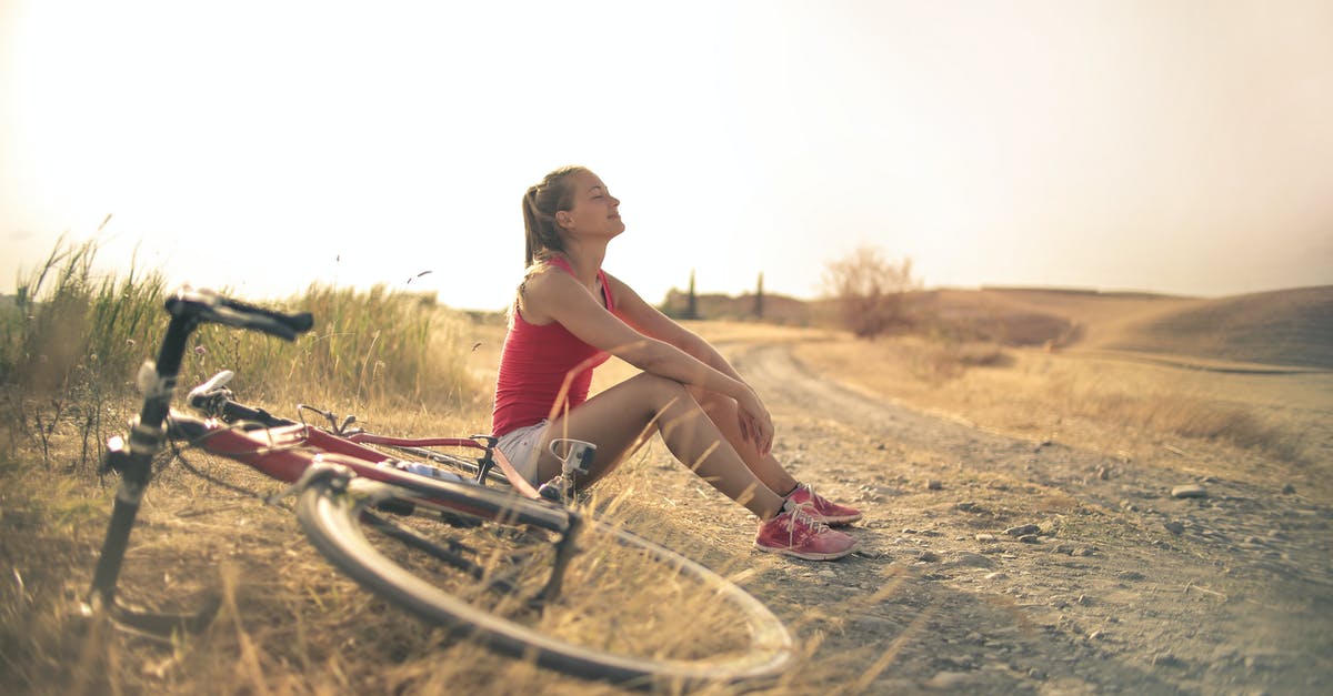 What does Limit Break actually do? - Full body of female in shorts and top sitting on roadside in rural field with bicycle near and enjoying fresh air with eyes closed