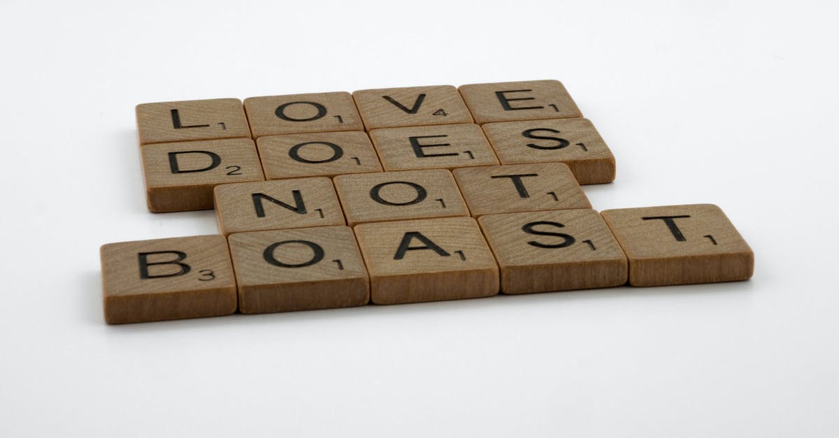 What does "immune to errors" mean? - Close-Up Shot of Scrabble Tiles on a White Surface