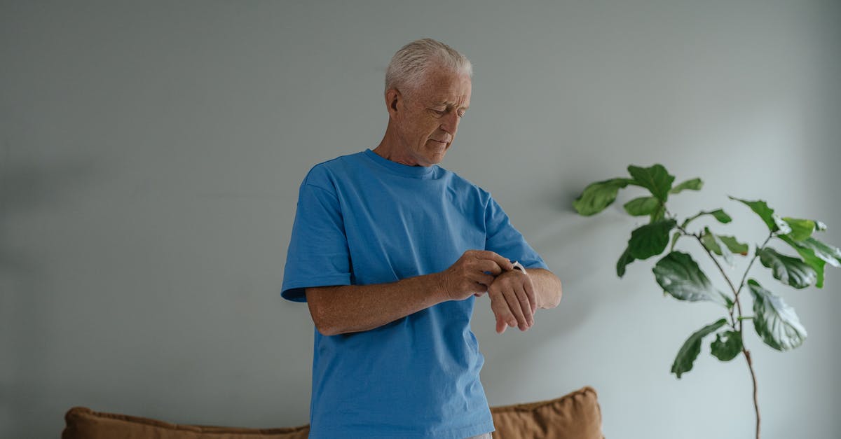 What does "overpowered" do in Time Clickers? - Man in Blue Crew Neck T-shirt Standing Near Brown Sofa