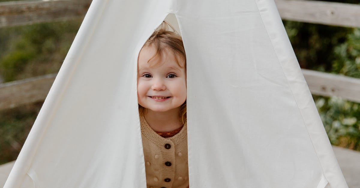 What does the 'Play in Starships' button do? - Happy little child smiling while peeking from tent