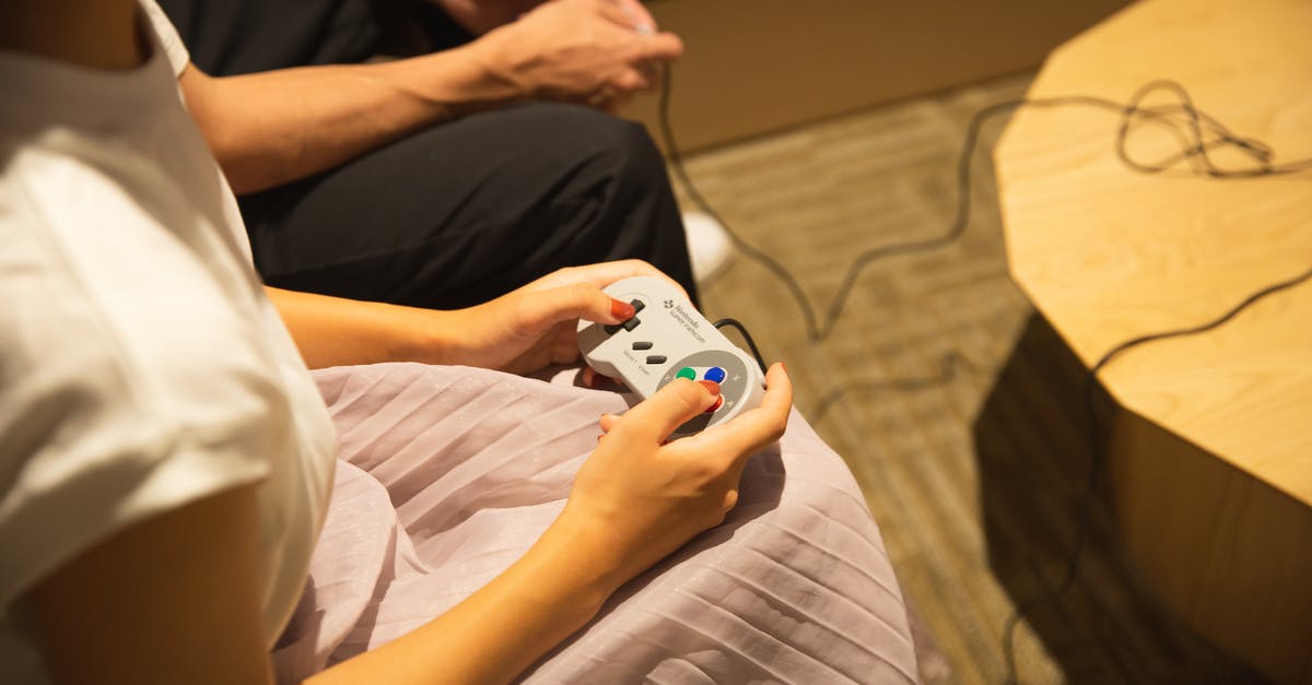 What does the 'Play in Starships' button do? - Unrecognizable couple playing video game with gamepads at home