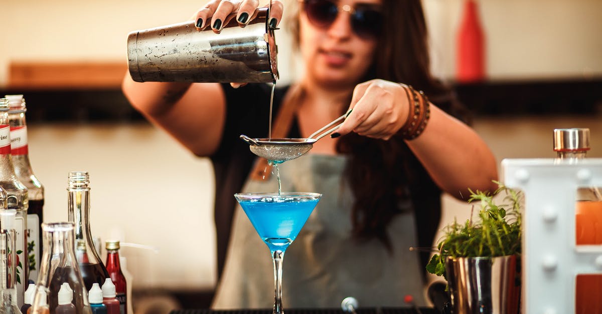 What does the blue bar in the experience bar mean? - Blurred stylish woman in sunglasses pouring blue alcoholic drink with strainer into cocktail glass at counter