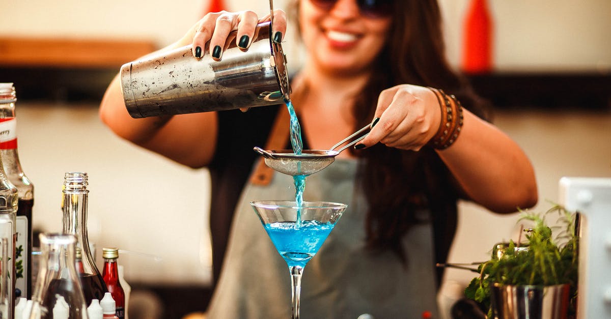 What does the blue bar in the experience bar mean? - Crop cheerful woman preparing homemade blue cocktail in bar