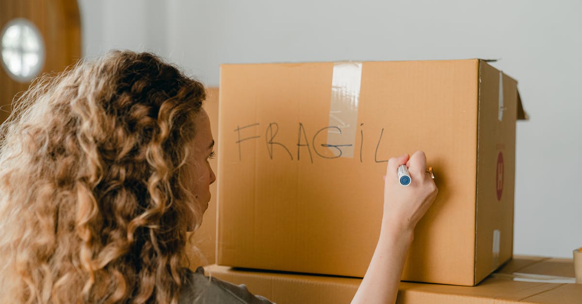 What does the bonus item from completing the Darker Side do? - Back view of unrecognizable curvy female in casual clothes writing fragile on empty side of carton box while waiting for courier