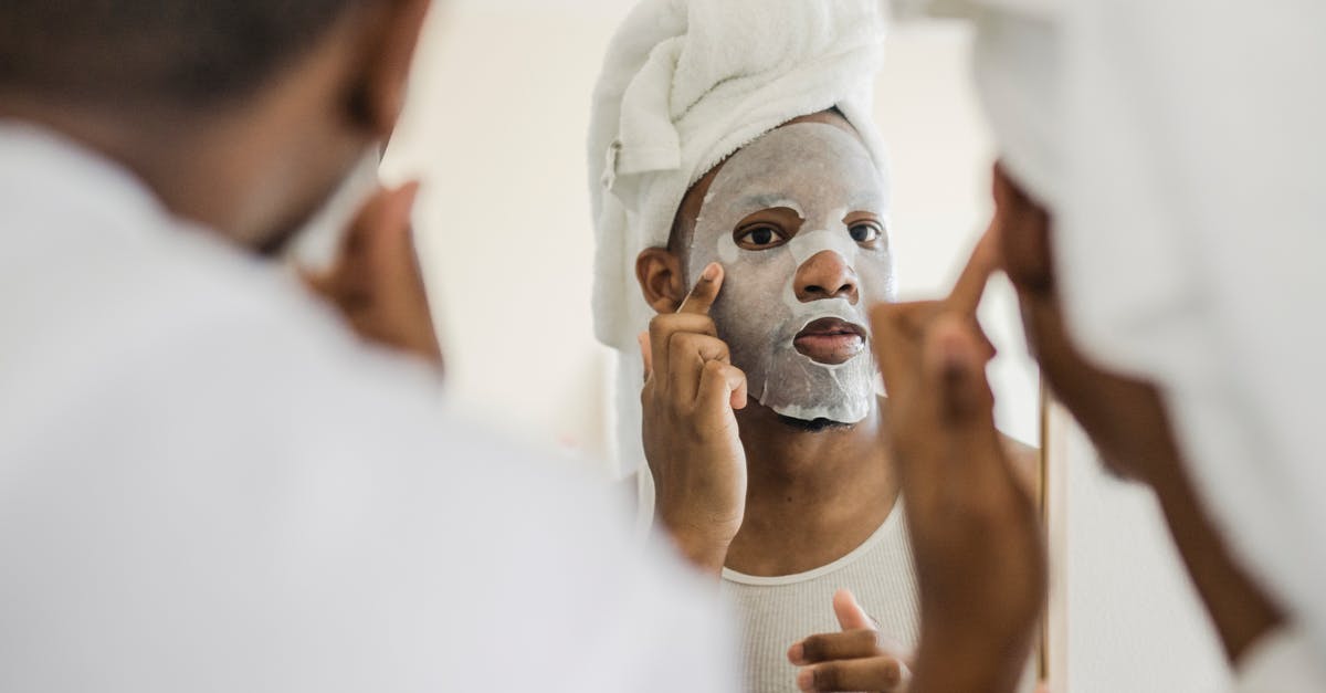 What does the mirror do? - Men Looking in Mirror Doing Facial Procedures