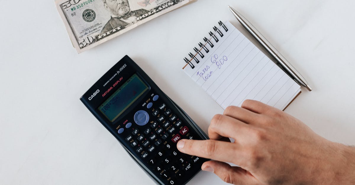 What does this hand and number represent? - Crop faceless accountant using calculator while making budget