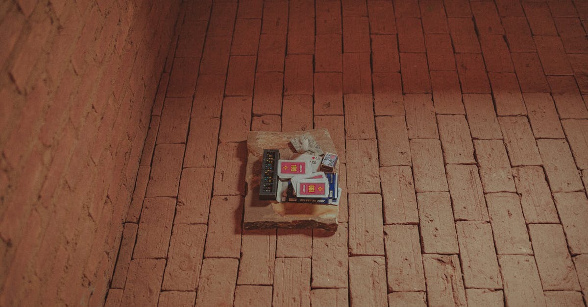 What game is this city screen from? - From above of domino and card decks placed together with matches on brick aged pavement