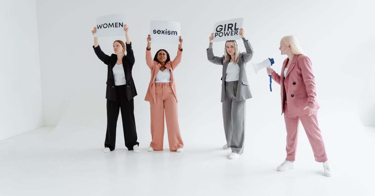 What happens if clan leaders abuse their power? - Women in Blazer and Pants Standing while Protesting