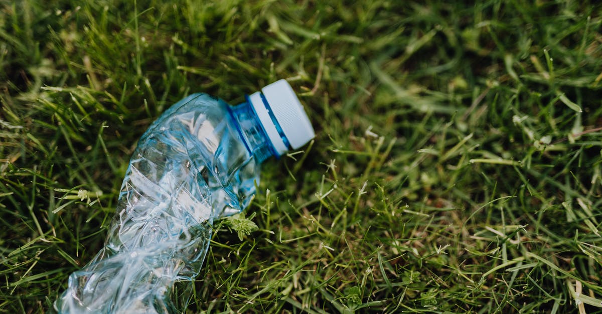 What happens to extra materials from salvaged junk? - From above of blue crumpled plastic bottle thrown on green park lawn on sunny summer day