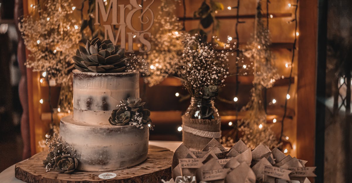 What happens to my boarding party if the enemy ship surrenders? - Wedding cake placed on wooden board near glass bottle with fresh blooming delicate flowers