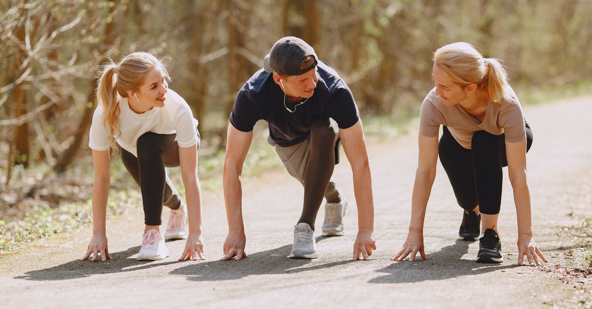 What is a challenge swap and how do I use it? - Group of cheerful athletes in sportswear in ready pose for sprinting together during fitness workout and running in spring park