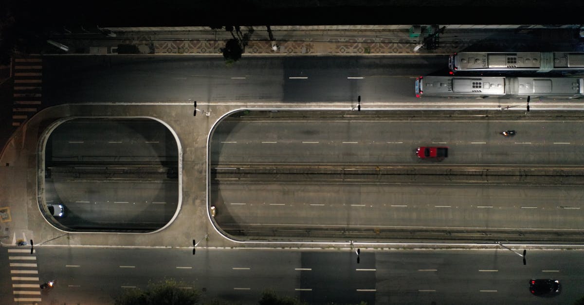 What is a lane? - White and Red Bus on Road during Night Time