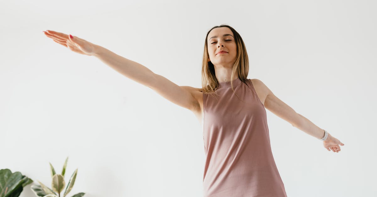 What is Silent mode in Ring Fit Adventure? - From below of calm young female performing Warrior II yoga asana with extended arms and closed eyes