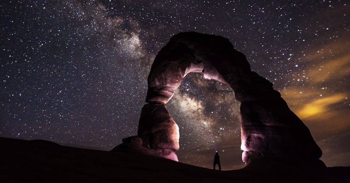 What is that diamond/cone formation in the Satisfactory promo? - Person Standing Under A Rock Formation On A Starry Night