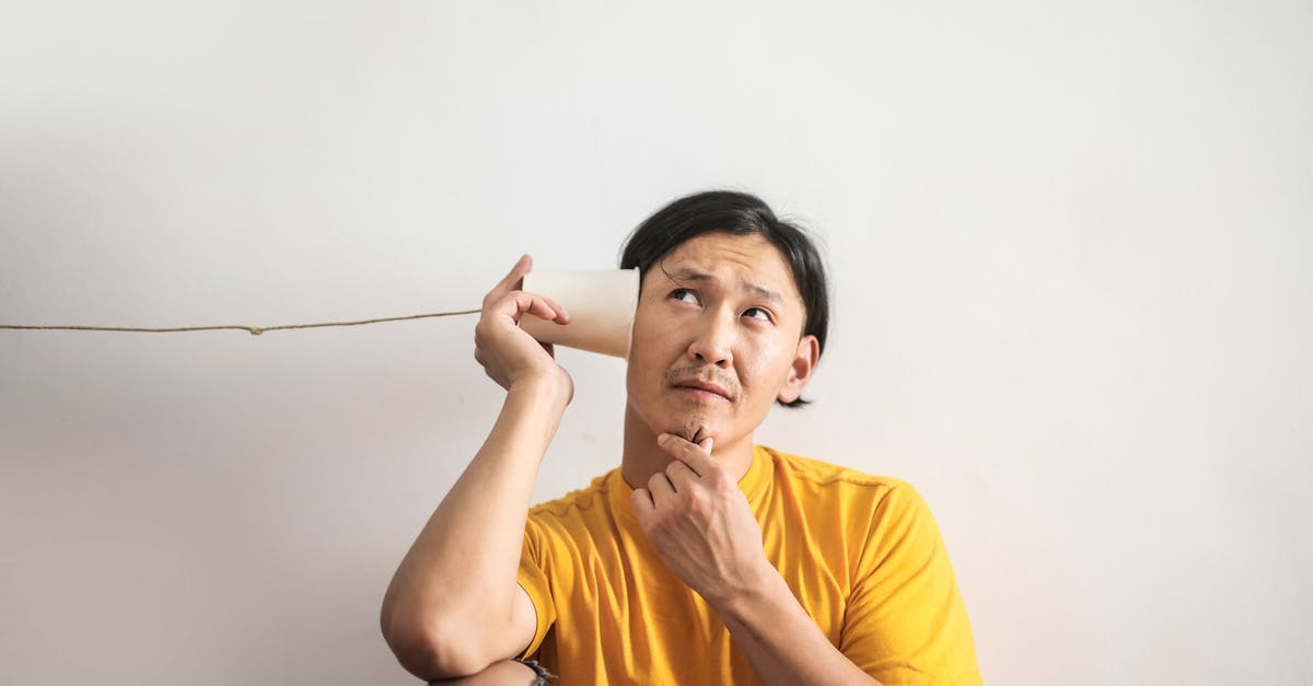 What is the answer to this logic? - Pensive ethnic man listening to answer in paper cup phone