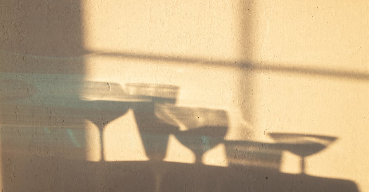 What is the difference between Crystallize and Crystallize+? - Shadows of different crystal glasses filled with drinks reflecting on white wall in sunlight