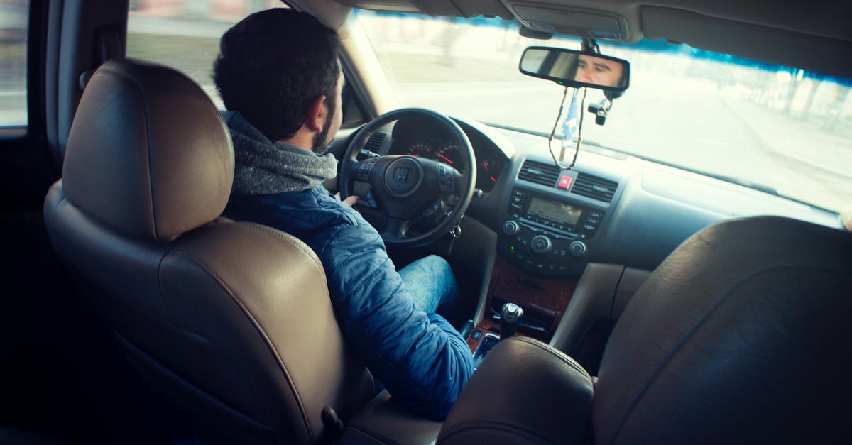 What is the difference between Steering Non-Linearity and Steering Sensitivity? - Man Wearing Blue Jacket Sitting Inside Car While Driving