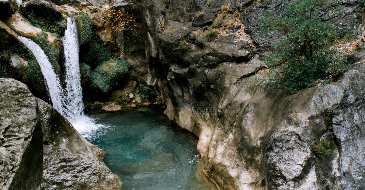 What is the difference between the Circle-K and Lawson Power Cube? - Picturesque scenery of high waterfall falling in water stream between  rocky mountains