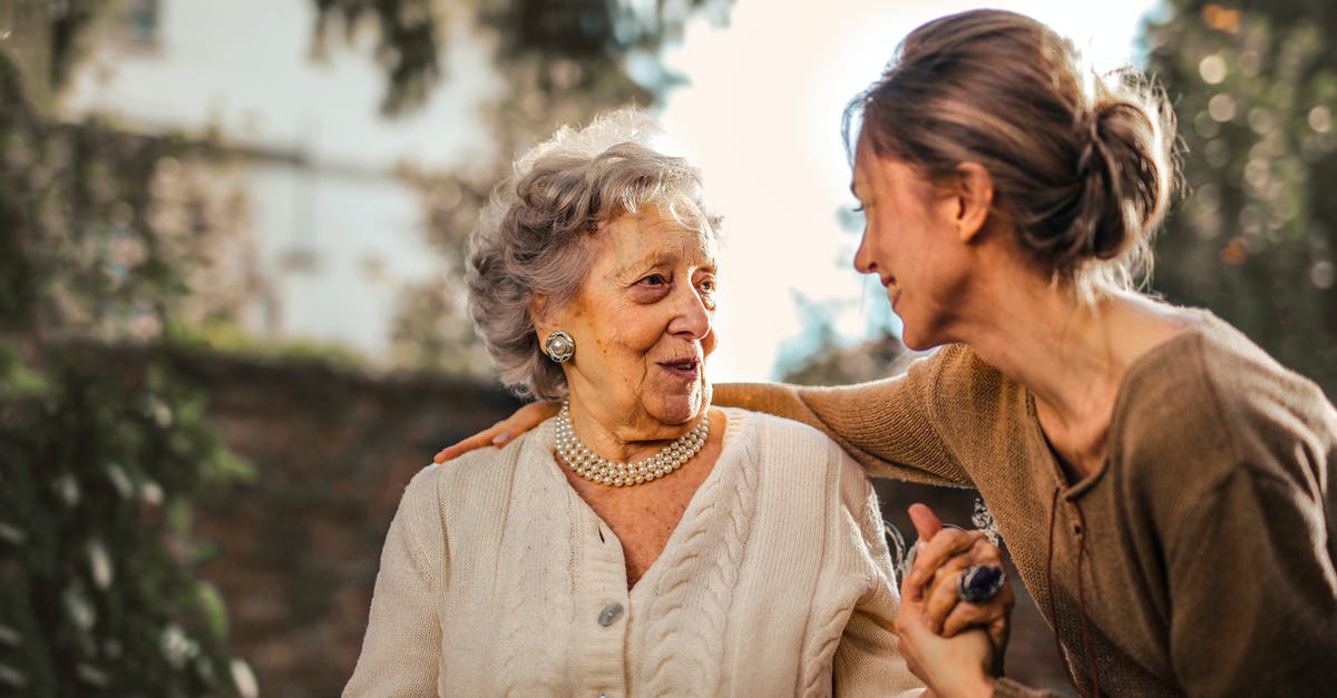 What is the interaction between Angelic Ward and Damage Dispersion? - Joyful adult daughter greeting happy surprised senior mother in garden