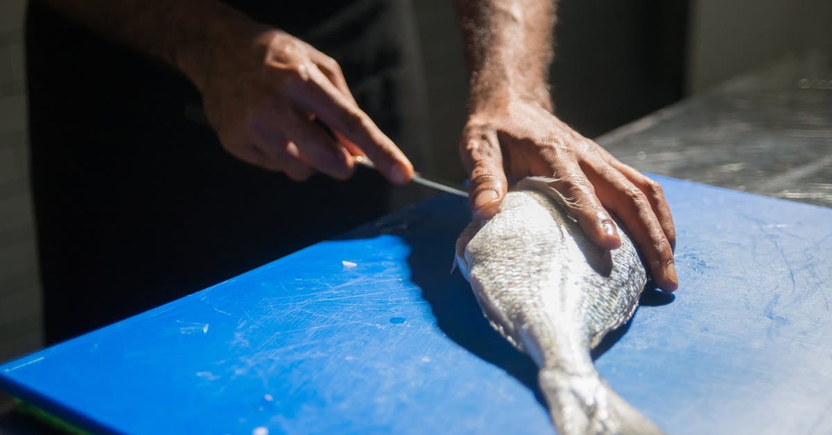 What is the maximum amount of fish you can have? - Person Holding White Textile on Blue Table