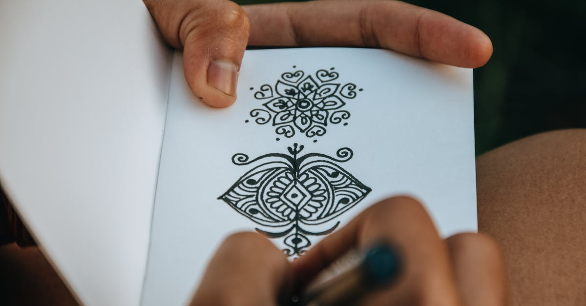 What is the meaning of 'pp' in OSU? - Crop anonymous talented person creating difficult mehendi sketch in album with white sheets