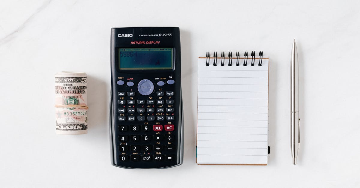 What is the number above towers? - Composition of calculator with paper money and notebook with pen