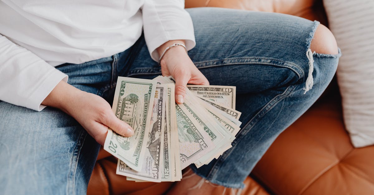 What is the range for the grenade launcher attachment? - Low Section of a Woman Sitting on a Leather Sofa and Showing Dollar Banknotes