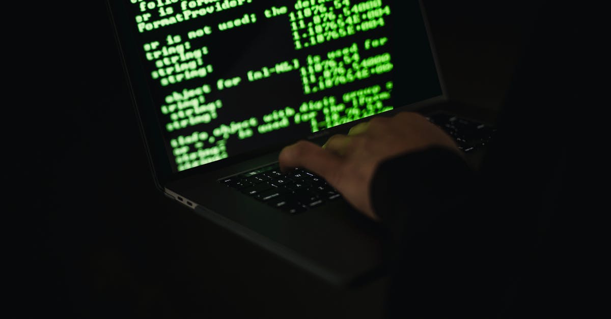 What is the required cracker to hack into NSA? - Crop hacker typing on laptop with information on screen