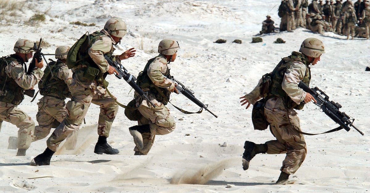 What is the strange occurrence in the combat simulator? - 5 Soldiers Holding Rifle Running on White Sand during Daytime