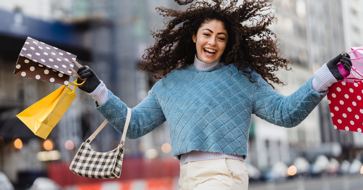 What is there to spend my rupees on? - Happy woman jumping with shopping bags