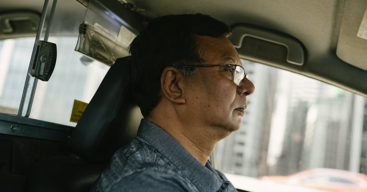 What is this downtown side job during the Corpo prologue? - Side view of ethnic male in eyeglasses and casual clothes looking away while driving car What is this downtown side job during the Corpo prologue? - Side view of ethnic male in eyeglasses and casual clothes looking away while driving car