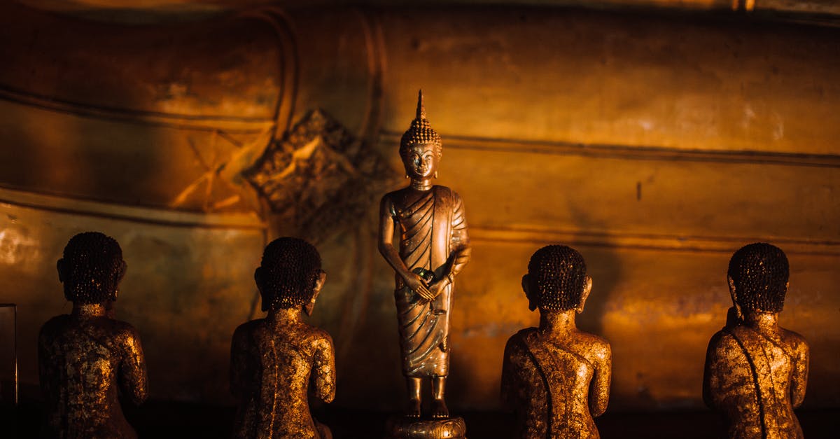 What is this golden sword? - Gold Buddha Figurine on Brown Wooden Table