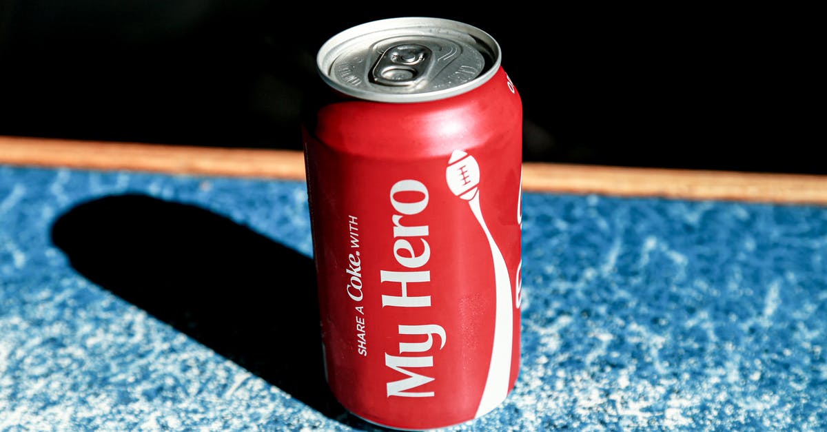 What metals can be extracted from what items? - From above of red metal can with refreshing fizzing coke placed on table in cafe