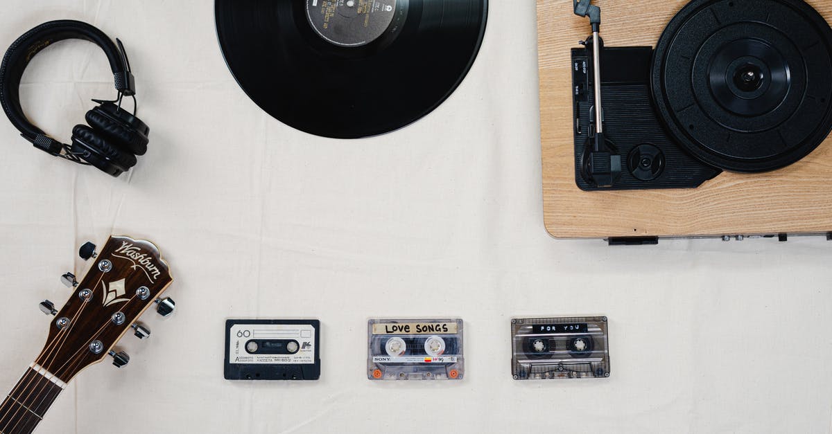 What songs is Lucio playing? - Black Vinyl Record on White Table