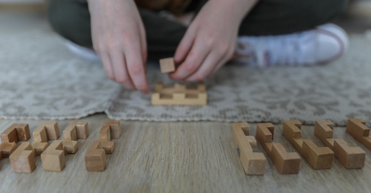 What this secret floor puzzle at the entrance activates? - Crop girl playing blocks on carpet