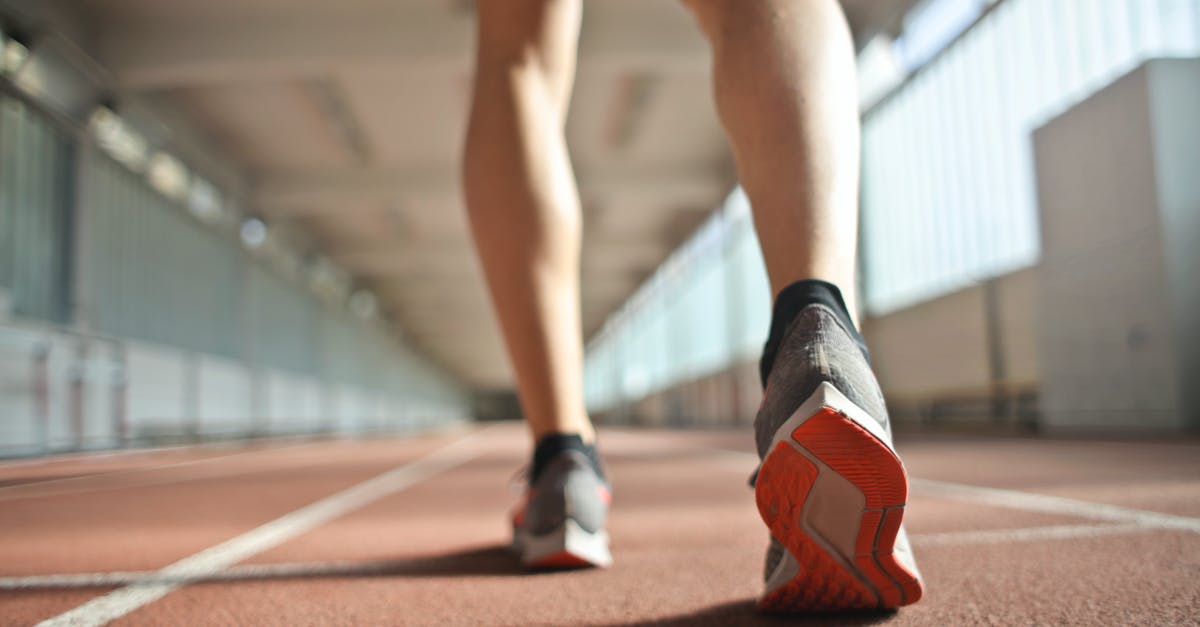 When am I ready for sunglasses? - Fit runner standing on racetrack in athletics arena