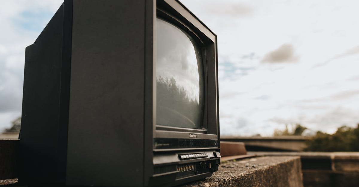 When do Cloud saves happen? Mine are outdated - Small black old fashioned television placed on stone barrier against cloudy sky in city on sunny street on blurred background