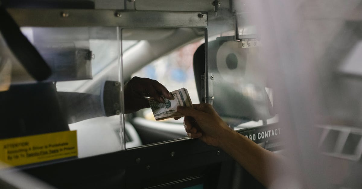 When does dashing through shots actually work? - View through open window of unrecognizable driver accepting payment in cash from crop customer sitting on back seat