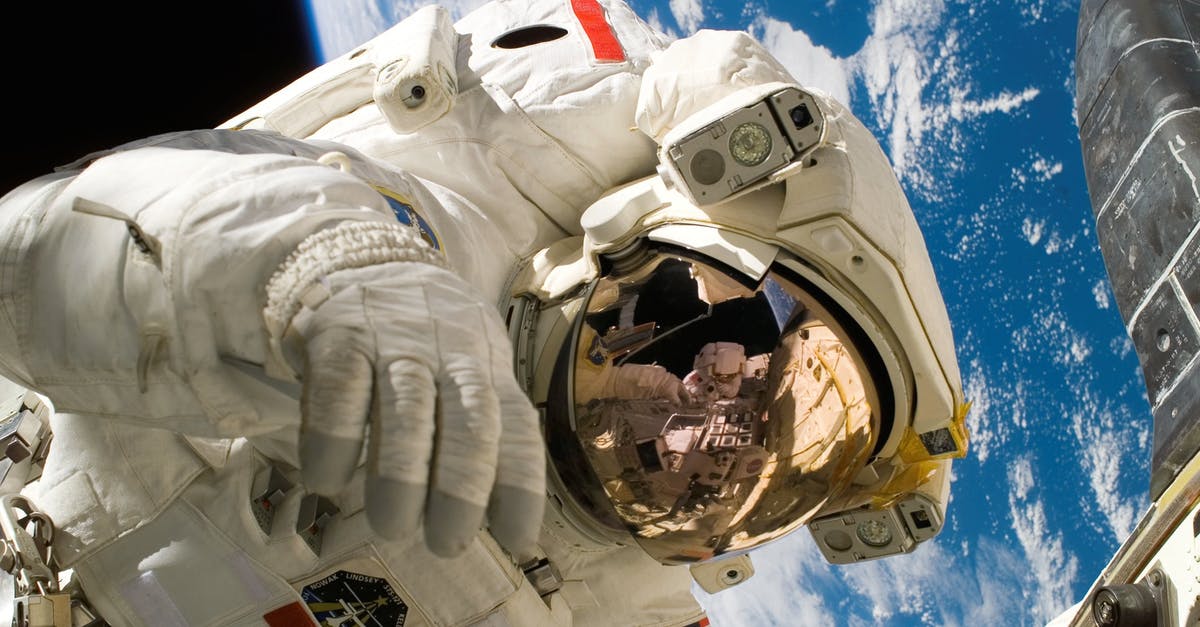 When is it possible to travel to the Americas? - This picture shows an american astronaut in his space and extravehicular activity suite working outside of a spacecraft. In the background parts of a space shuttle are visible. In the far background of the picture planet earth with it's blue color and whi When is it possible to travel to the Americas? - This picture shows an american astronaut in his space and extravehicular activity suite working outside of a spacecraft. In the background parts of a space shuttle are visible. In the far background of the picture planet earth with it's blue color and whi