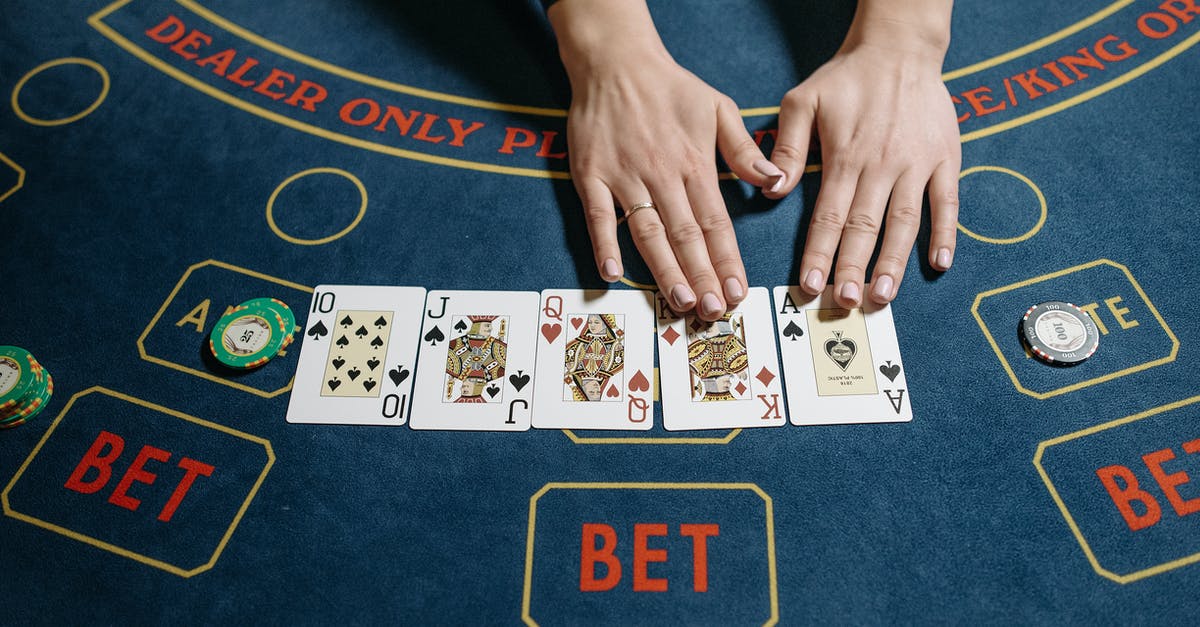 When to purposefully lose trophies - Casino Dealer Hands on Playing Cards