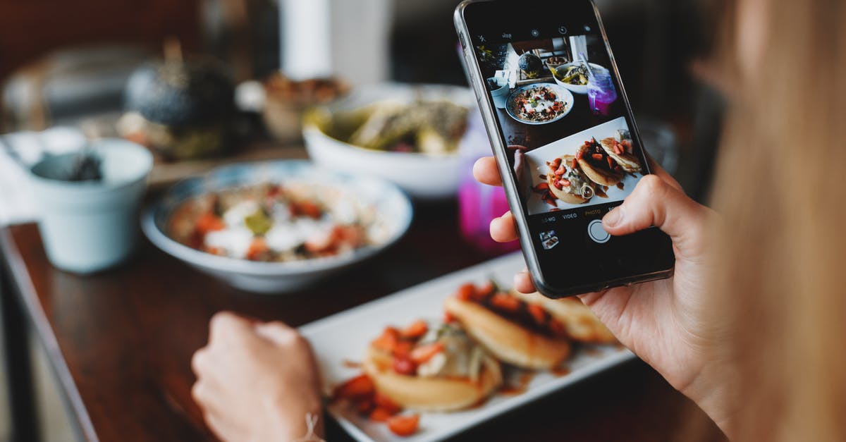 When using a capture card, where is my game displayed? - Crop anonymous female taking photo of various tasty dishes on smartphone sitting at table in modern cafe