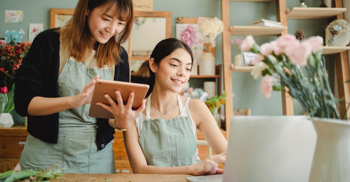 Where are screenshots taken in Overwatch on PC stored? - Happy multiracial women working on gadgets in floral store