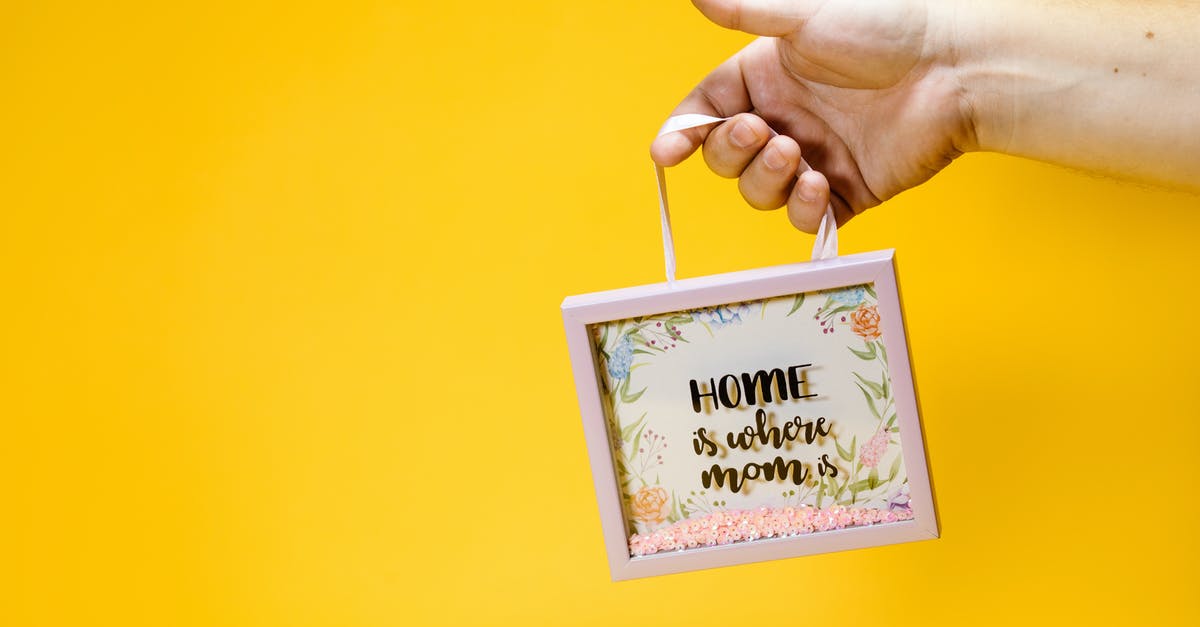 Where is Satan? - A Person Holding a Picture Frame with a Floral Design