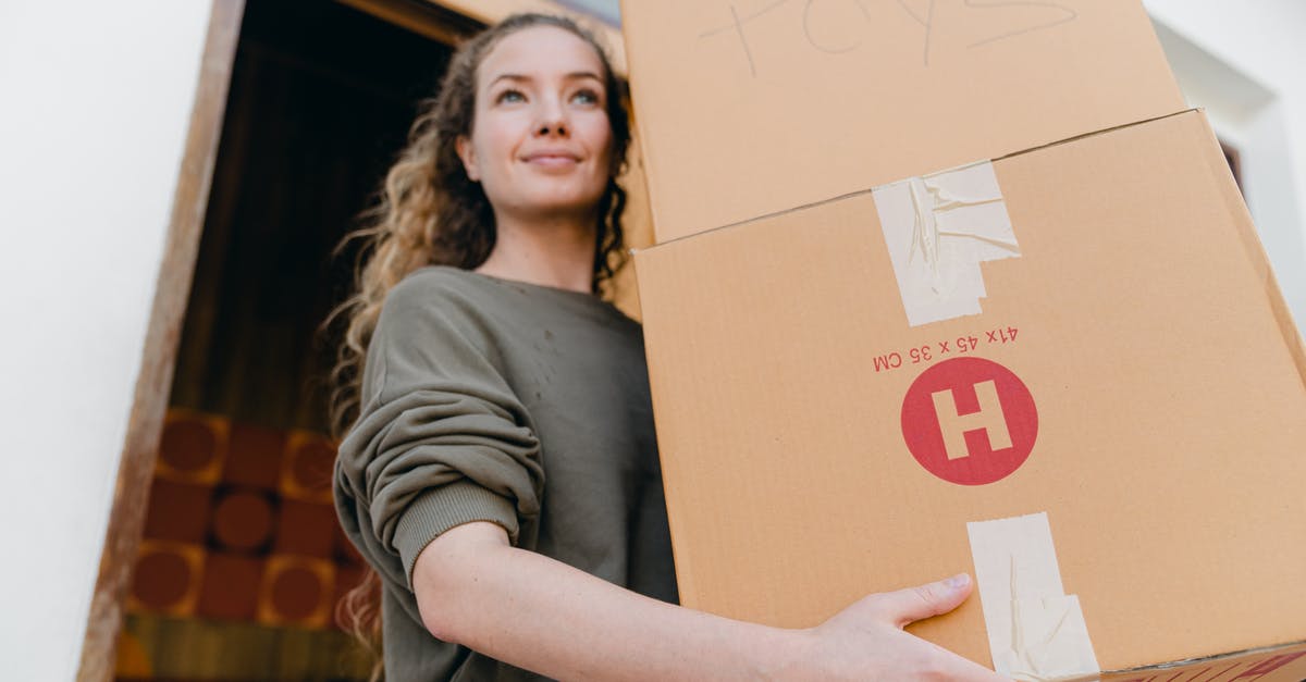 Where is the best place to find loads of dervish slimes? - Confident young lady in casual wear carrying heavy carton boxes with toys and looking away while leaving old house